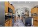 The kitchen features stainless steel appliances, natural wood cabinets, and stone counters at 12221 Orchardgrass Ln, Raleigh, NC 27614