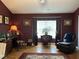 Spacious living room with hardwood floors, vintage decorations, and a cozy reading corner at 12221 Orchardgrass Ln, Raleigh, NC 27614