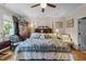 Spacious main bedroom with a ceiling fan, ensuite bathroom, and lovely natural light from the window at 12221 Orchardgrass Ln, Raleigh, NC 27614