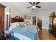 Charming main bedroom with a ceiling fan, ensuite bathroom, and gleaming hardwood floors at 12221 Orchardgrass Ln, Raleigh, NC 27614