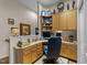 Office with built in shelving, hardwood floors, and desk at 12221 Orchardgrass Ln, Raleigh, NC 27614