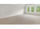 Carpeted bedroom featuring three windows allowing for ample natural light at 123 Pony Gallop Ln, Clayton, NC 27520
