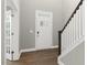 Inviting foyer with hardwood floors, stairs to the second level, and a door leading to another room at 123 Pony Gallop Ln, Clayton, NC 27520