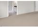 Carpeted hallway that leads to a bathroom with tile floors, white cabinets and countertop at 123 Pony Gallop Ln, Clayton, NC 27520