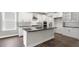Kitchen featuring white cabinets, stainless steel appliances, dark countertops, and a large island at 123 Pony Gallop Ln, Clayton, NC 27520
