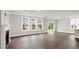 Bright living area with a fireplace, large windows, and sliding glass doors to the outside at 123 Pony Gallop Ln, Clayton, NC 27520