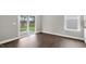 Bright living room with hardwood floors and sliding glass doors to the outdoor space at 123 Pony Gallop Ln, Clayton, NC 27520