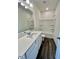 A bright bathroom features gray flooring, a white vanity, and a shower-tub combo at 124 N Keatts Winner Ct, Wilson's Mills, NC 27520