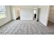 A large bedroom features three doorways and neutral carpet at 124 N Keatts Winner Ct, Wilson's Mills, NC 27520