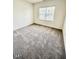 Bright bedroom featuring neutral carpeting and a window with a view of the outdoors at 124 N Keatts Winner Ct, Wilson's Mills, NC 27520