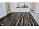 This move-in ready home features stylish, wood-look flooring, leading to a modern kitchen with an island at 124 N Keatts Winner Ct, Wilson's Mills, NC 27520