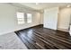 Spacious living room with wood floors, large windows, and plenty of natural light at 124 N Keatts Winner Ct, Wilson's Mills, NC 27520