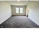 A spacious room with large windows features neutral carpeting and ample natural light at 124 N Keatts Winner Ct, Wilson's Mills, NC 27520