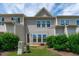 The backyard features well-maintained landscaping, a patio, and a rear entrance to the home at 127 Bowerbank Ln, Apex, NC 27539