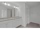 A bathroom featuring a double sink, granite countertops, and a large mirror at 127 Bowerbank Ln, Apex, NC 27539