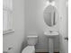 Small bathroom with pedestal sink, toilet, and dark wood floors at 127 Bowerbank Ln, Apex, NC 27539