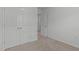 A bedroom featuring neutral carpeting, crisp white walls, and a double door closet at 127 Bowerbank Ln, Apex, NC 27539
