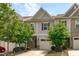 Traditional townhouse with attached garage and mature trees in front yard at 127 Bowerbank Ln, Apex, NC 27539