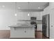 Well-lit kitchen with stainless steel appliances and granite countertops at 127 Bowerbank Ln, Apex, NC 27539