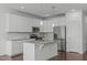 Bright kitchen with stainless steel appliances and granite countertops at 127 Bowerbank Ln, Apex, NC 27539