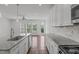 Open kitchen featuring granite counters, stainless appliances and natural light at 127 Bowerbank Ln, Apex, NC 27539