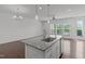 Open concept kitchen with granite island, stainless appliances and hardwood floor at 127 Bowerbank Ln, Apex, NC 27539