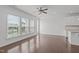 Hardwood floors, large windows, and view to the kitchen in open-concept living space at 127 Bowerbank Ln, Apex, NC 27539