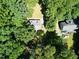 Aerial view of a house surrounded by lush greenery showing a tree-filled landscape at 129 Clark Ct, Youngsville, NC 27596