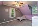 bedroom with gray and purple walls, a colorful patterned bed, carpet, and natural light at 129 Clark Ct, Youngsville, NC 27596