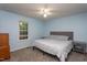 Cozy bedroom with a full bed, gray comforter, side tables, carpeted floor, and natural light from the window at 129 Clark Ct, Youngsville, NC 27596