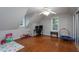 Attic bedroom with hardwood floors, desk, play area, and natural light at 129 Clark Ct, Youngsville, NC 27596