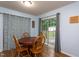 Light-filled dining area with wooden table, chairs, and sliding glass doors to a deck and backyard at 129 Clark Ct, Youngsville, NC 27596
