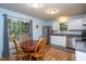 Bright kitchen with wood table, stainless steel appliances, ample counter space, and sliding glass door to the exterior at 129 Clark Ct, Youngsville, NC 27596