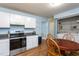Kitchen with stainless appliances and laminate flooring, next to a utility closet at 129 Clark Ct, Youngsville, NC 27596