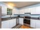 Functional kitchen featuring stainless steel appliances and white cabinets with a view to the exterior at 129 Clark Ct, Youngsville, NC 27596