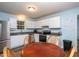 Well-lit kitchen with stainless steel appliances and wood table surrounded by light blue walls at 129 Clark Ct, Youngsville, NC 27596