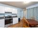 The kitchen features white cabinets, stainless steel appliances, and laminate flooring at 129 Clark Ct, Youngsville, NC 27596