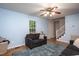 Well-lit living room with a ceiling fan, a cozy couch, and a nearby staircase at 129 Clark Ct, Youngsville, NC 27596