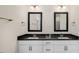 Modern bathroom features a double sink vanity with black countertops and matching framed mirrors at 135 Pony Gallop Ln, Clayton, NC 27520