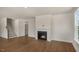 Open-concept living room featuring a fireplace, stairs, and natural light at 135 Pony Gallop Ln, Clayton, NC 27520