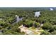 Scenic aerial view showcasing a beautiful lake surrounded by lush greenery and residential communities at 159 Clear Water Rd, Louisburg, NC 27549
