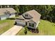 Charming two-story home featuring manicured lawn and landscaping, complemented by a long driveway and a two-car garage at 159 Clear Water Rd, Louisburg, NC 27549