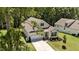 An aerial view of a well-maintained single-Gathering home with an attached two-car garage, manicured lawns and gardens at 159 Clear Water Rd, Louisburg, NC 27549