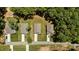 Neighborhood aerial showcasing multiple homes with manicured lawns, driveways, and mature trees at 159 Clear Water Rd, Louisburg, NC 27549