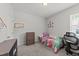 This carpeted bedroom features a single bed, a dresser, and a window with natural light at 159 Clear Water Rd, Louisburg, NC 27549
