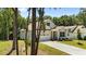 Two-story home featuring a well-manicured lawn and driveway, with a partial view through mature trees at 159 Clear Water Rd, Louisburg, NC 27549