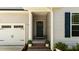 Home's entrance featuring a garage, a covered front porch with decorative plants leading to the front door at 159 Clear Water Rd, Louisburg, NC 27549