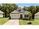 Charming single-Gathering home featuring a two-car garage, well-manicured lawn and lush landscaping at 159 Clear Water Rd, Louisburg, NC 27549