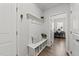 Hallway featuring a coat rack with a bench and storage beneath leading to a bedroom at 159 Clear Water Rd, Louisburg, NC 27549