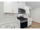Modern kitchen with stainless steel appliances, white cabinets, and sleek countertops at 159 Clear Water Rd, Louisburg, NC 27549
